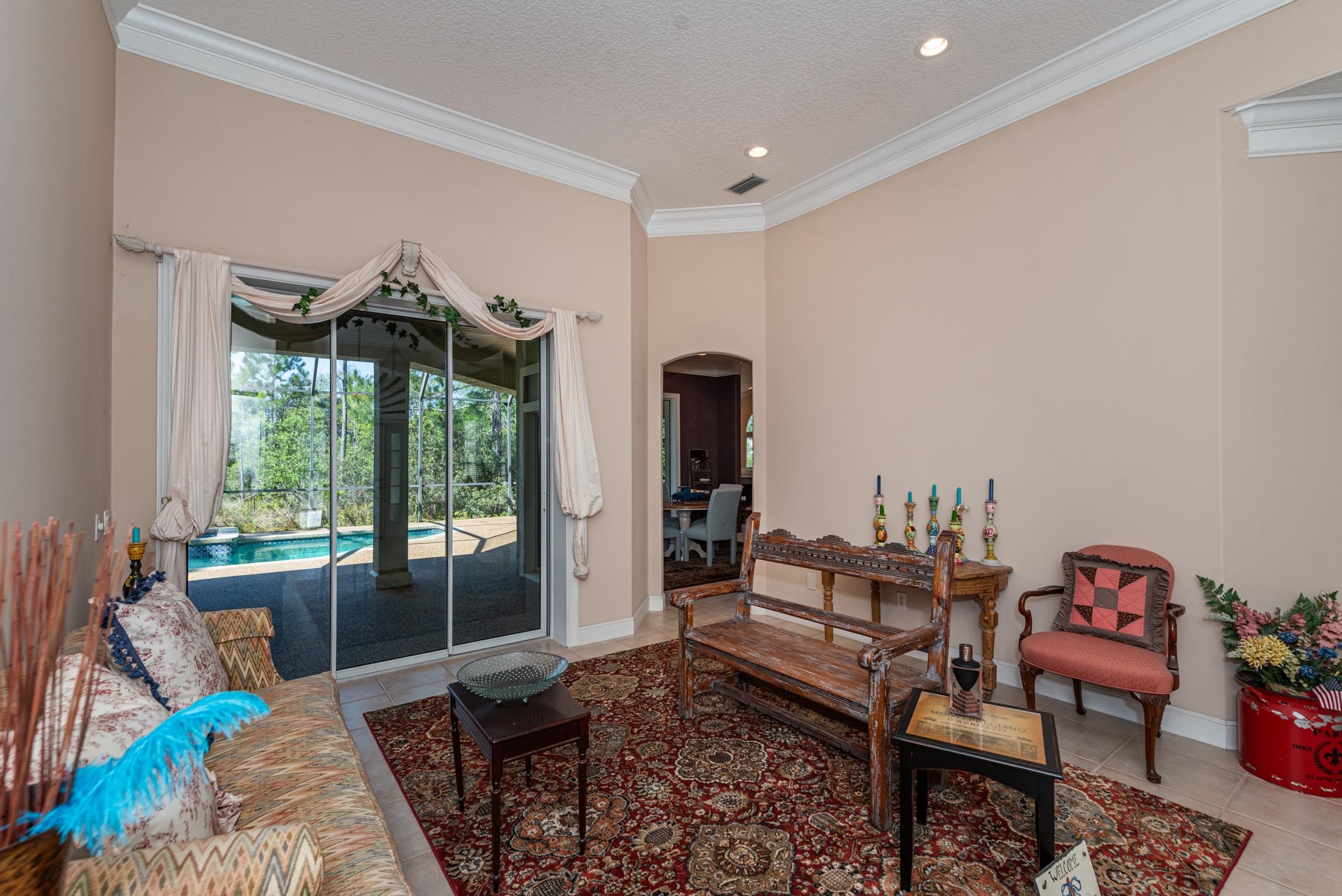 239 Marshside Drive St. Augustine, FL 32080 - Photo 13 of 57 a living room with furniture and a floor to ceiling window