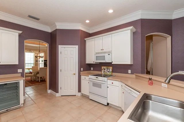 a dining room with furniture a rug and a floor to ceiling window