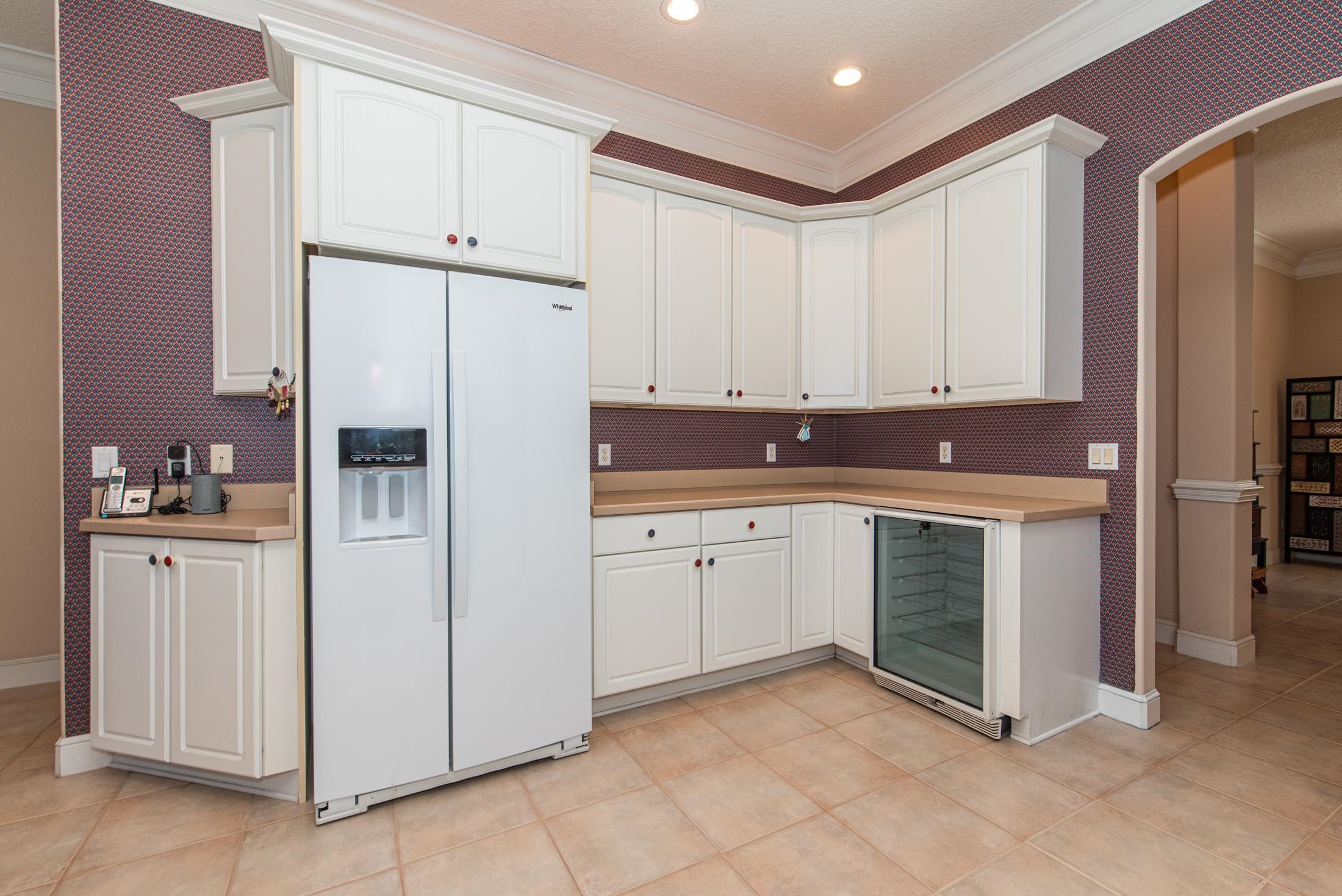 239 Marshside Drive St. Augustine, FL 32080 - Photo 18 of 57 a kitchen with stainless steel appliances granite countertop a refrigerator sink and white cabinets