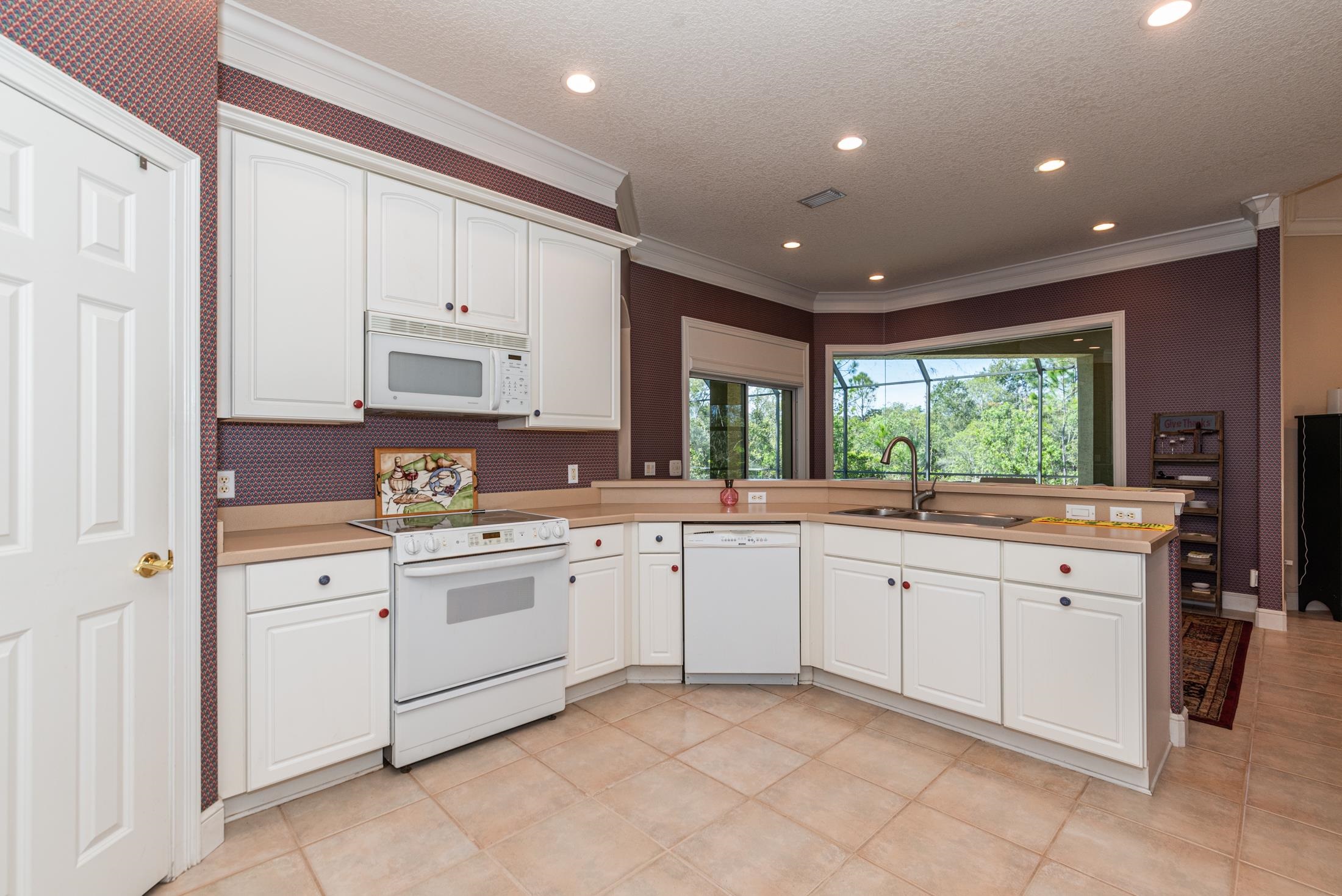 239 Marshside Drive St. Augustine, FL 32080 - Photo 19 of 57 a large white kitchen with a large window