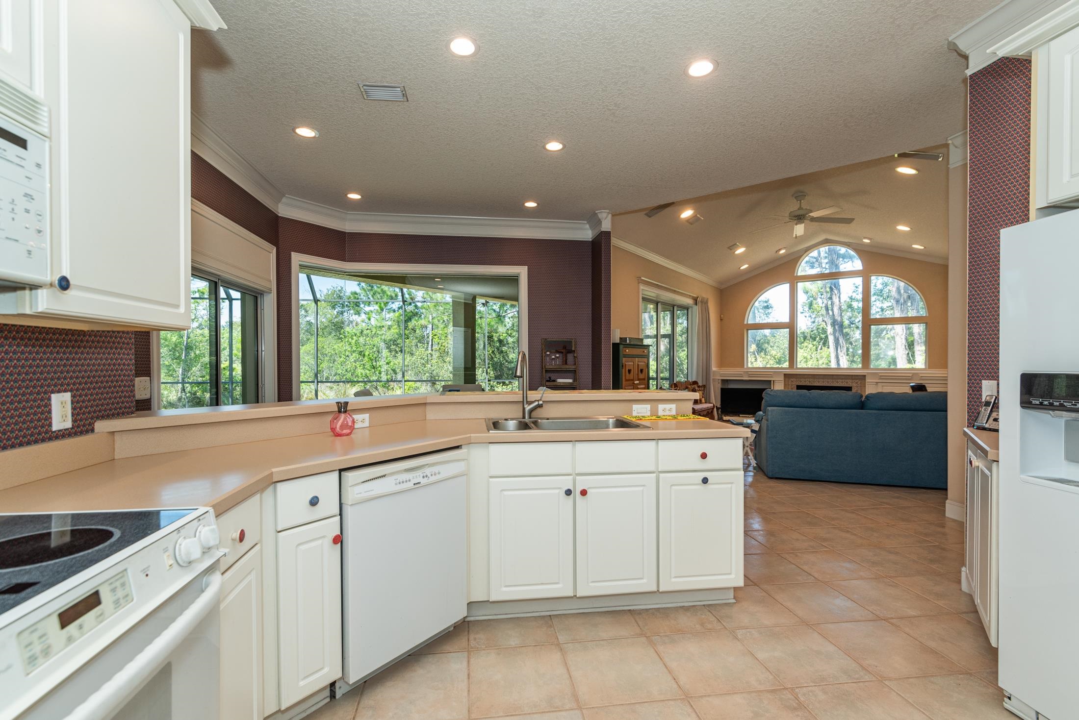 239 Marshside Drive St. Augustine, FL 32080 - Photo 20 of 57 a large kitchen with a large counter top a sink a window and stainless steel appliances