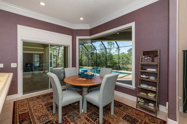 a living room with furniture a fireplace and a floor to ceiling window
