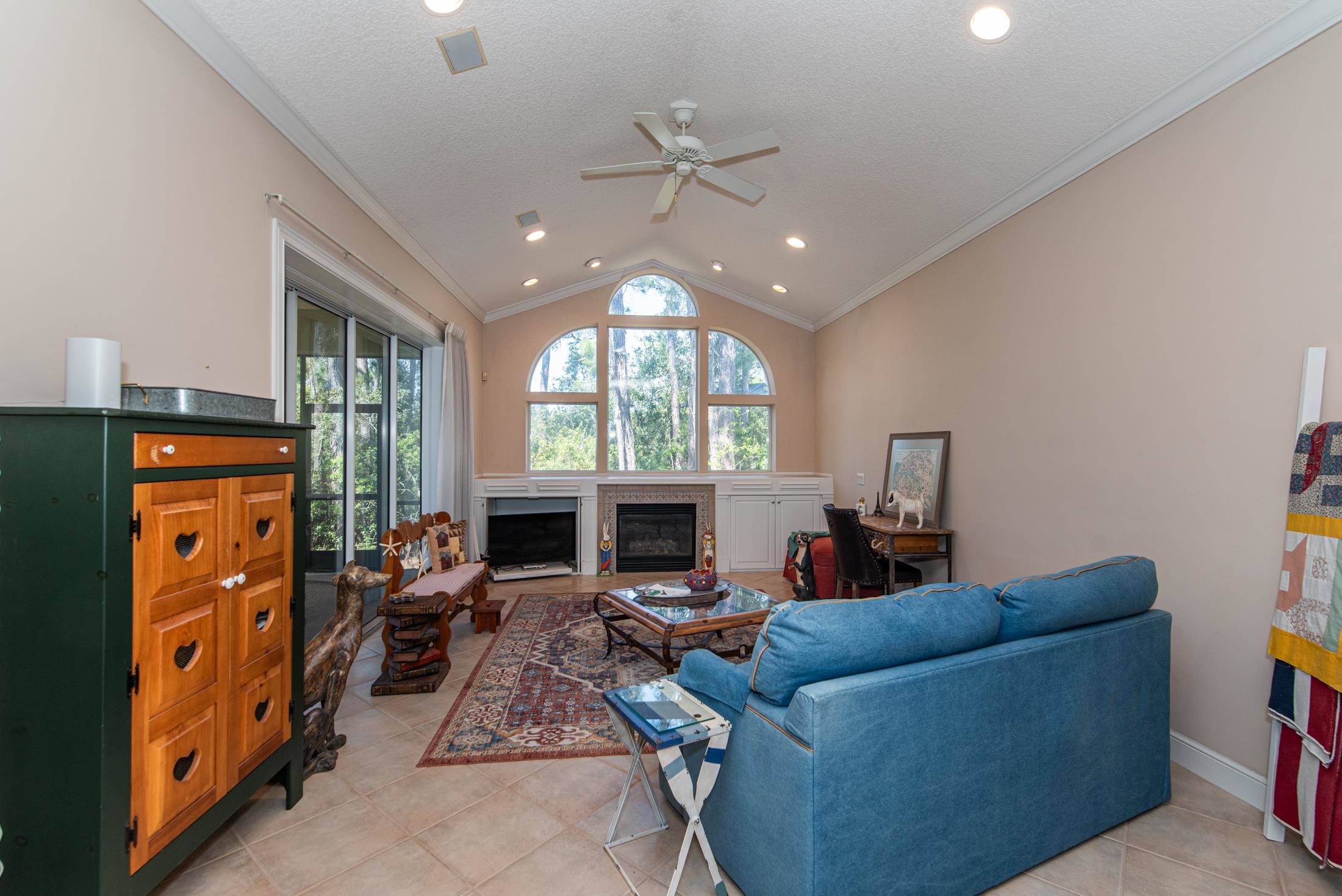 239 Marshside Drive St. Augustine, FL 32080 - Photo 25 of 57 a living room with furniture a fireplace and a chandelier