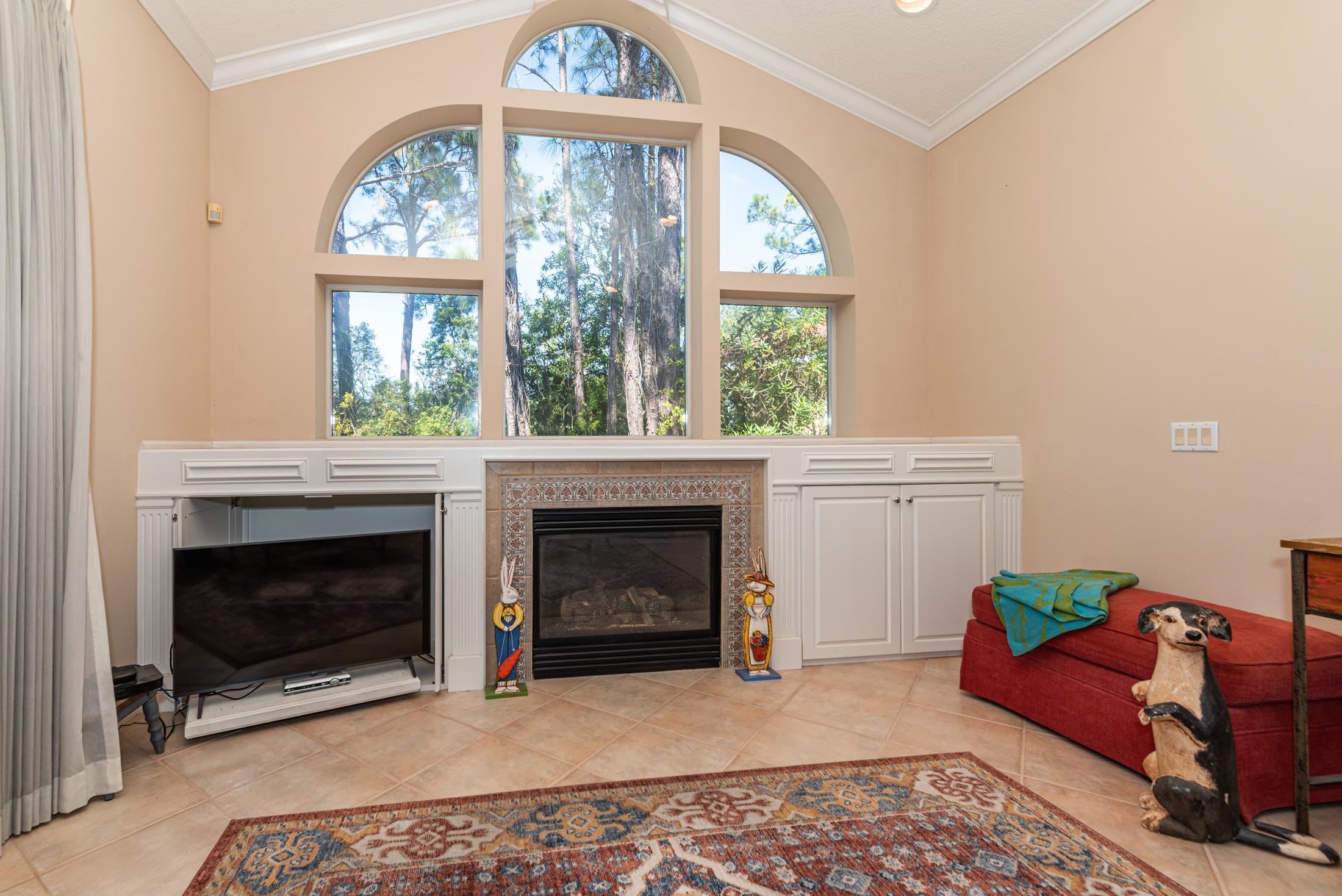 239 Marshside Drive St. Augustine, FL 32080 - Photo 27 of 57 a living room with furniture a window and a fireplace