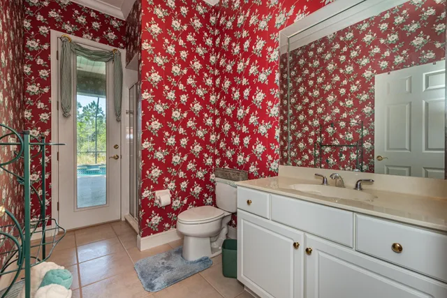 a spacious en suite bathroom with a large tub sink and mirror