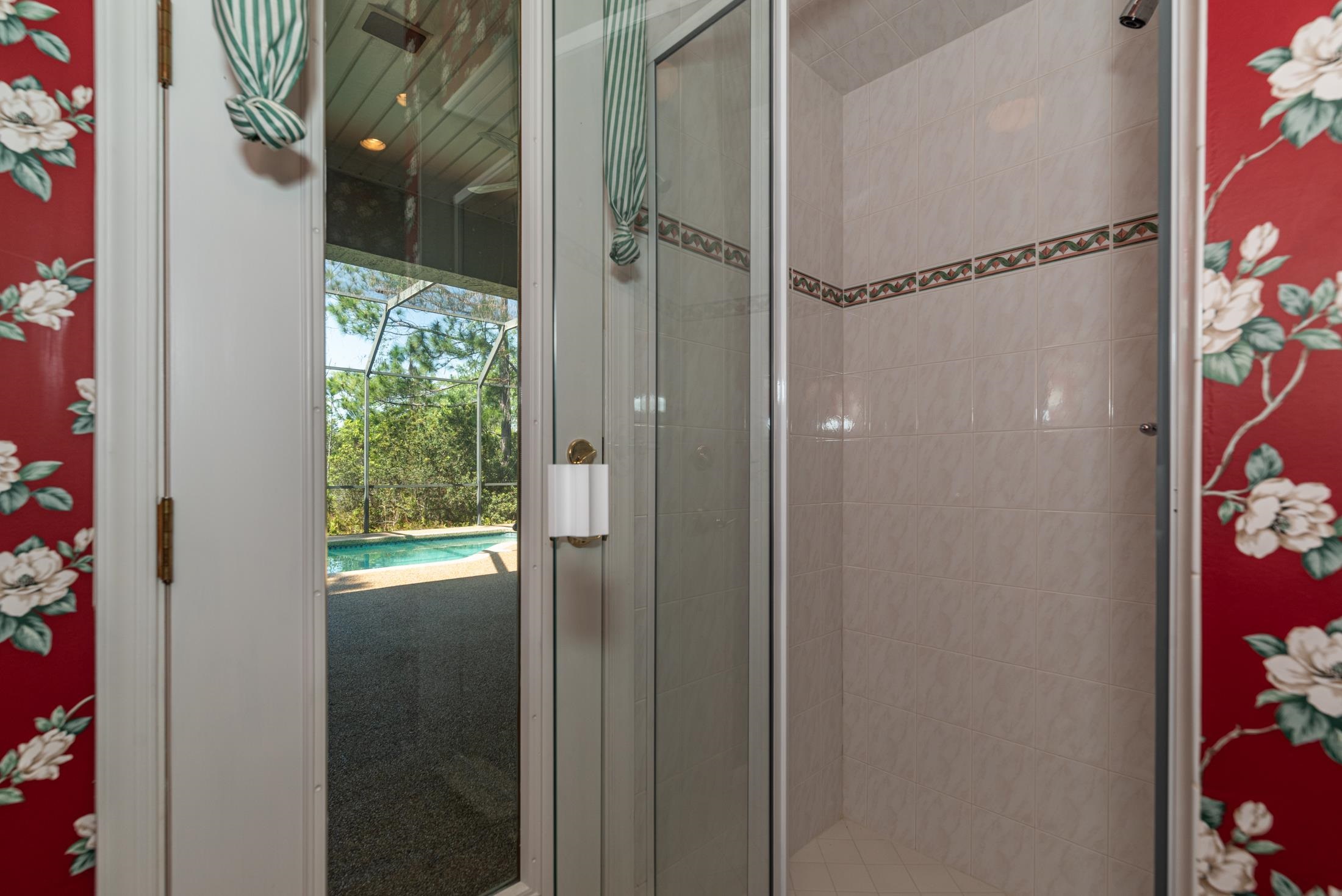 239 Marshside Drive St. Augustine, FL 32080 - Photo 41 of 57 a bathroom with a glass shower door