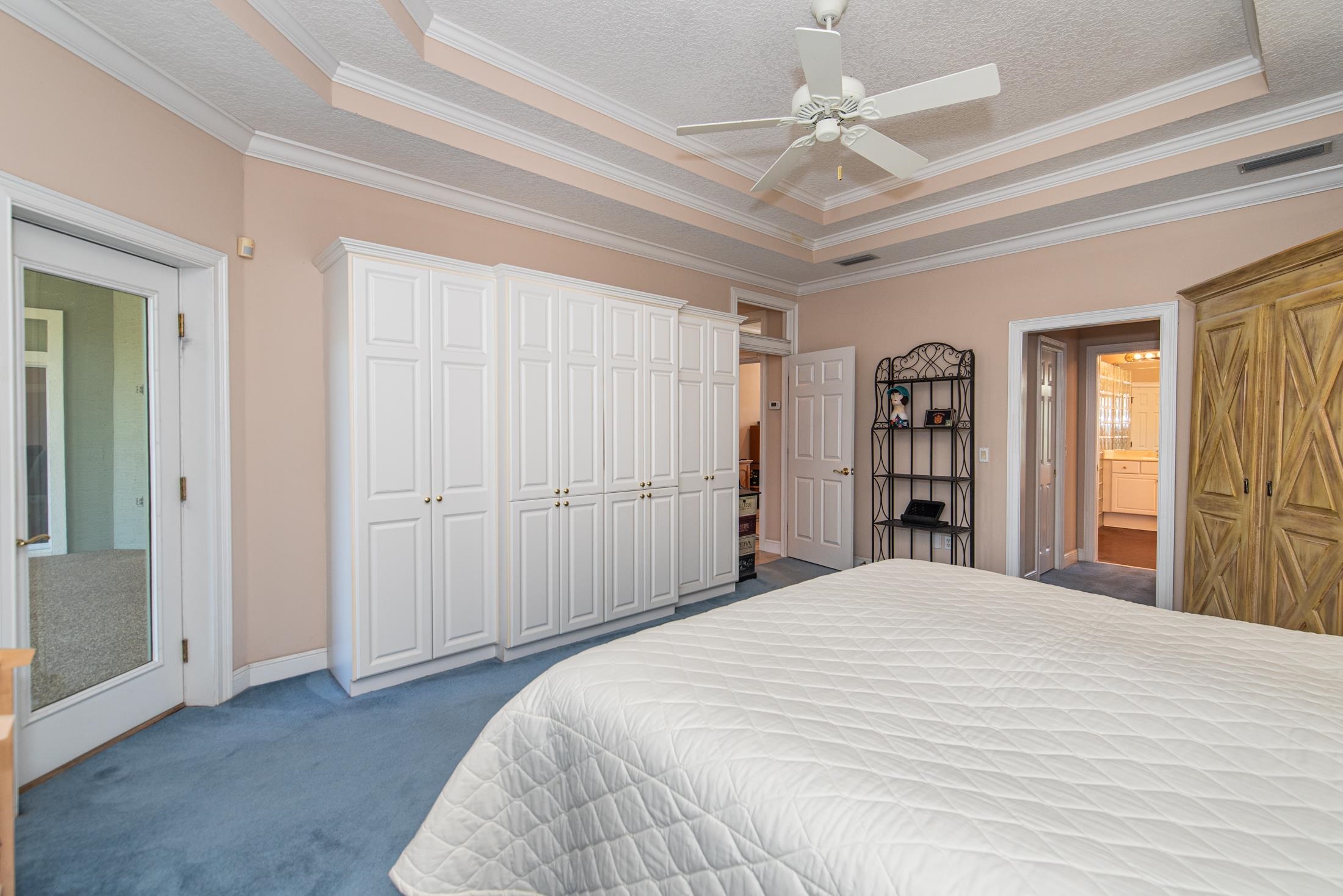 239 Marshside Drive St. Augustine, FL 32080 - Photo 45 of 57 a bedroom with a large bed and a chandelier