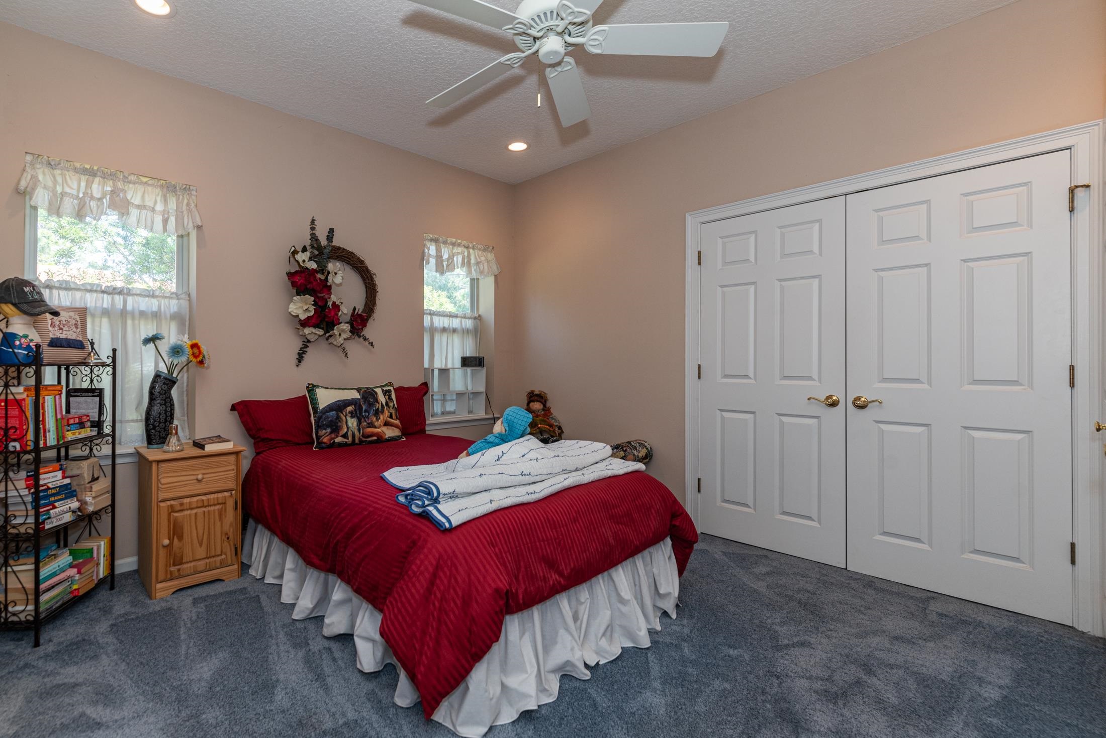 239 Marshside Drive St. Augustine, FL 32080 - Photo 49 of 57 a bedroom with a bed and a chandelier