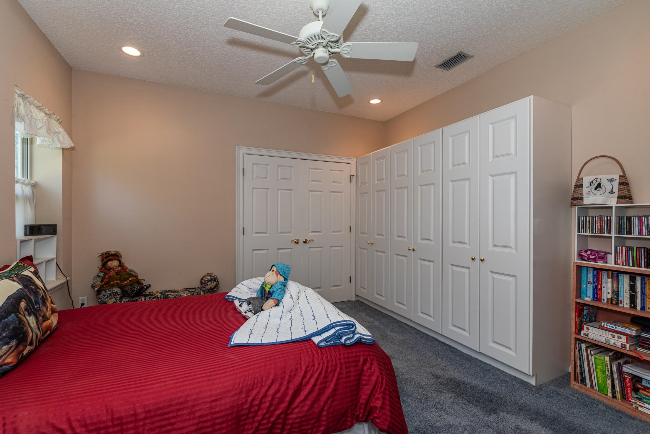 239 Marshside Drive St. Augustine, FL 32080 - Photo 50 of 57 a bedroom with a bed dresser and a book shelf