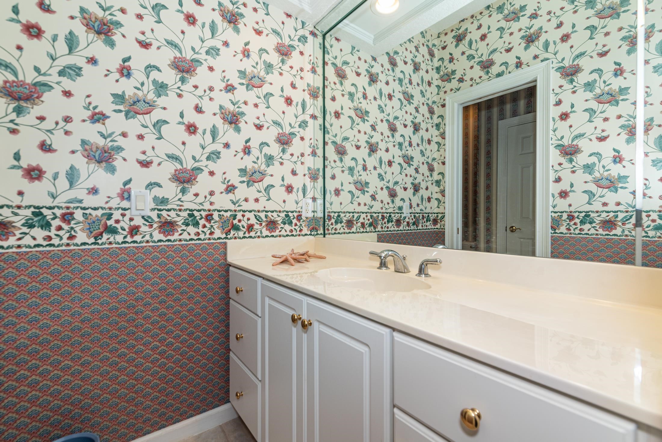 239 Marshside Drive St. Augustine, FL 32080 - Photo 52 of 57 a bathroom with a sink and mirror