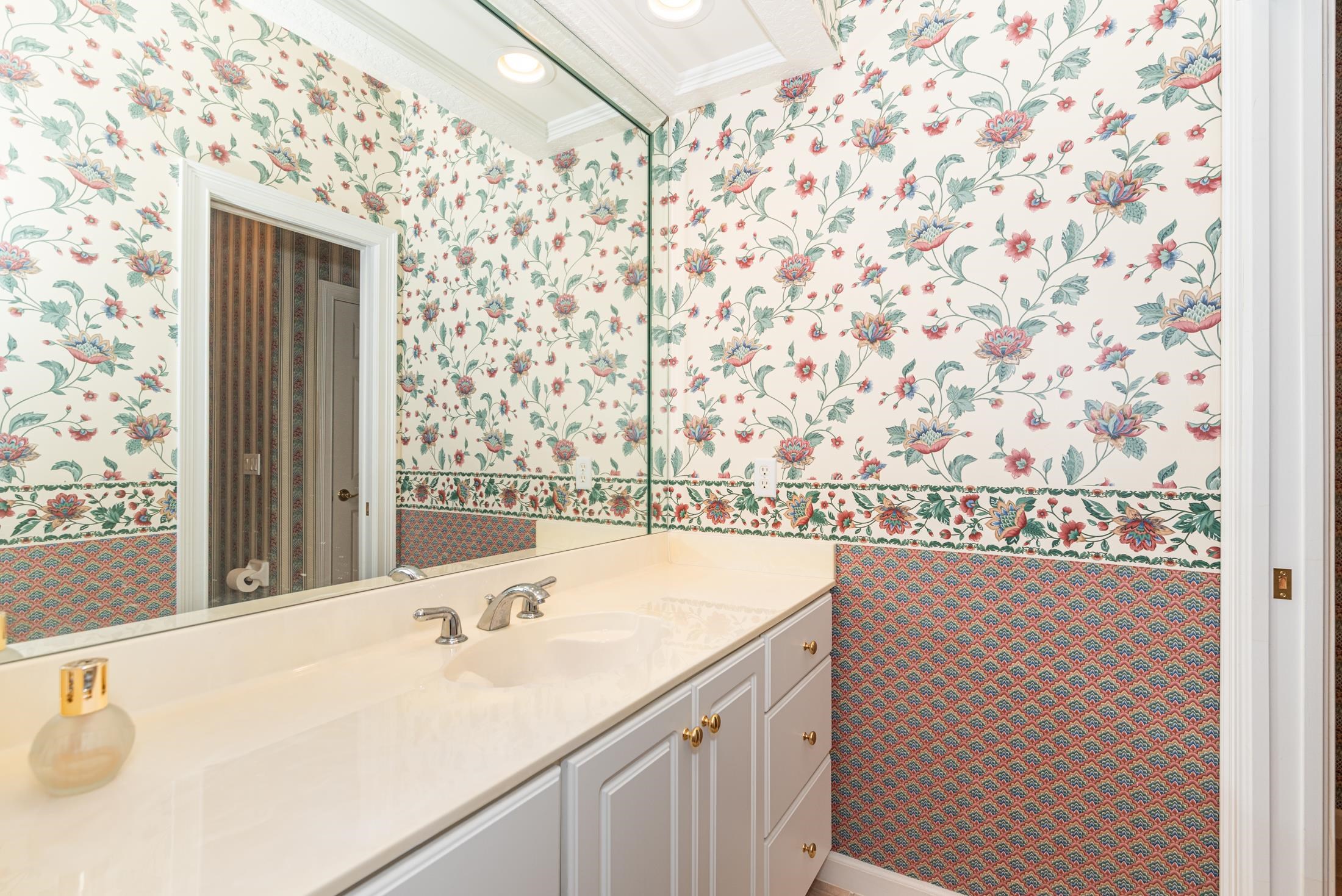 239 Marshside Drive St. Augustine, FL 32080 - Photo 55 of 57 a bathroom with a sink and a large mirror