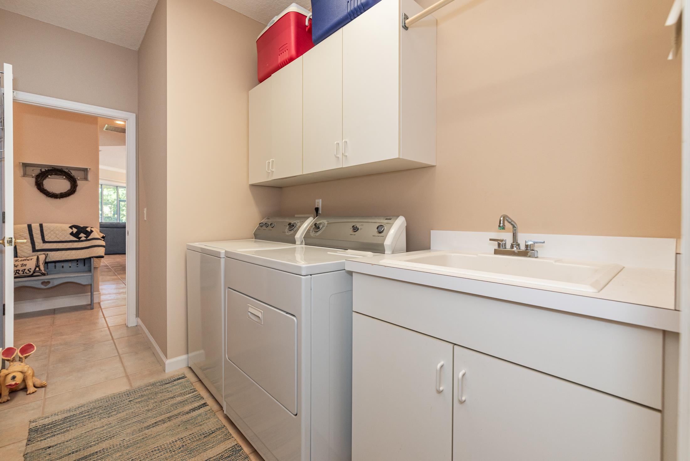 239 Marshside Drive St. Augustine, FL 32080 - Photo 56 of 57 a utility room with sink dryer and washer