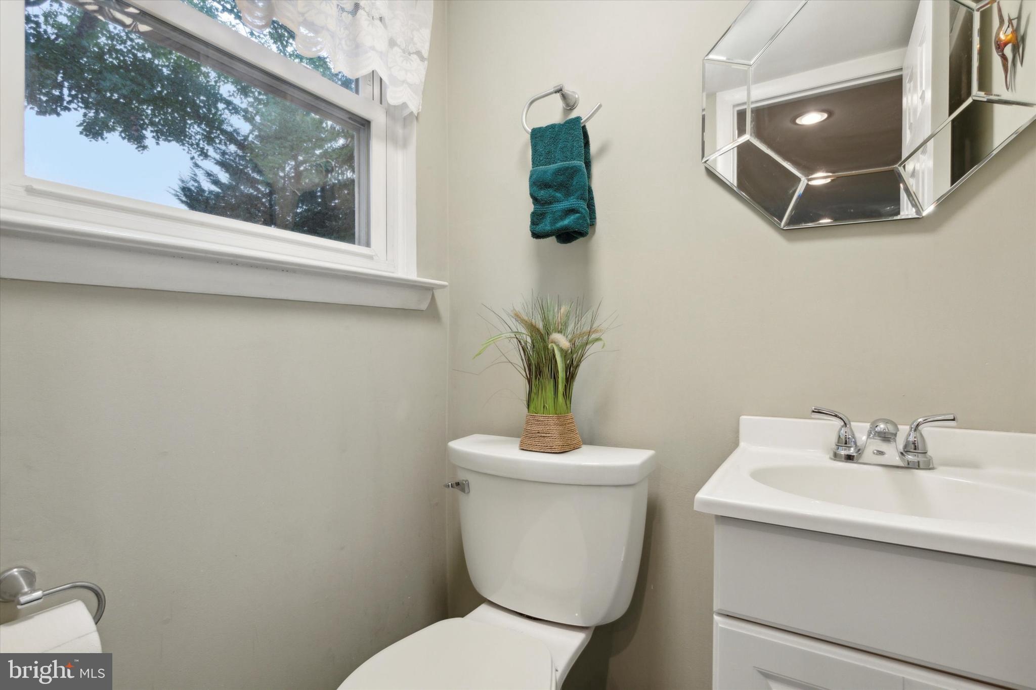 512 Schick Road Aston, PA 19014 - Photo 23 of 25 a white toilet sitting next to a bathroom sink
