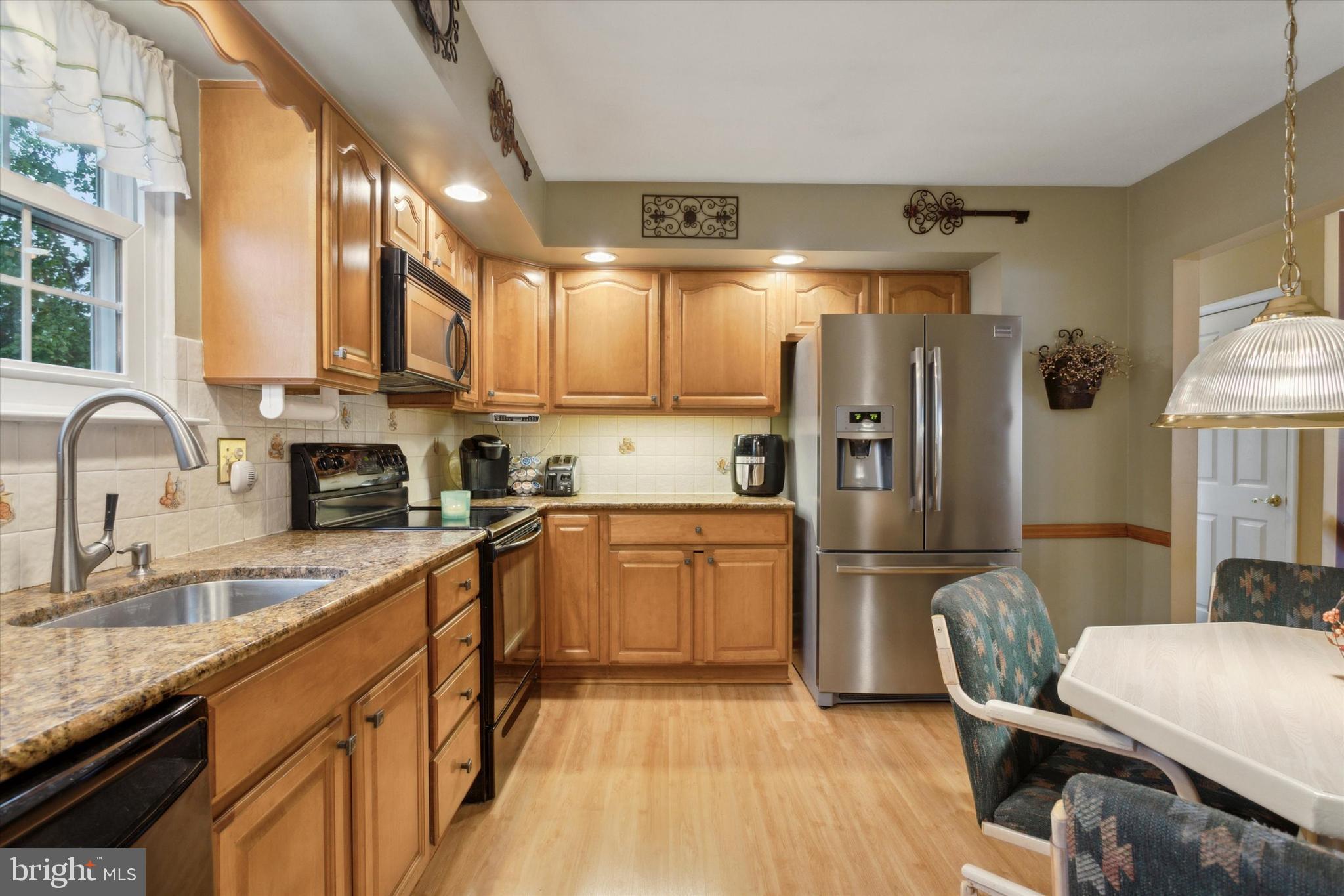 512 Schick Road Aston, PA 19014 - Photo 8 of 25 a kitchen with granite countertop a refrigerator stove top oven and sink