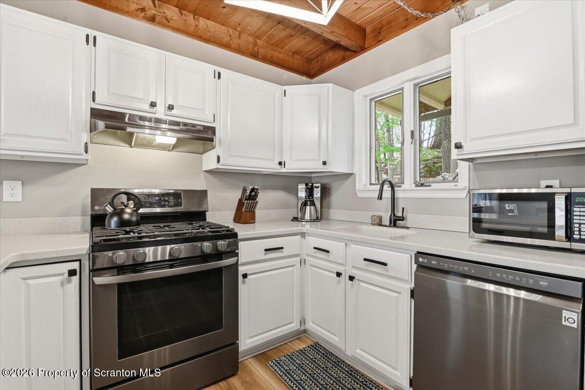 10 Knollwood Road Lake Ariel, PA 18436 - Photo 11 of 60 a kitchen with stainless steel appliances white cabinets and a stove top oven
