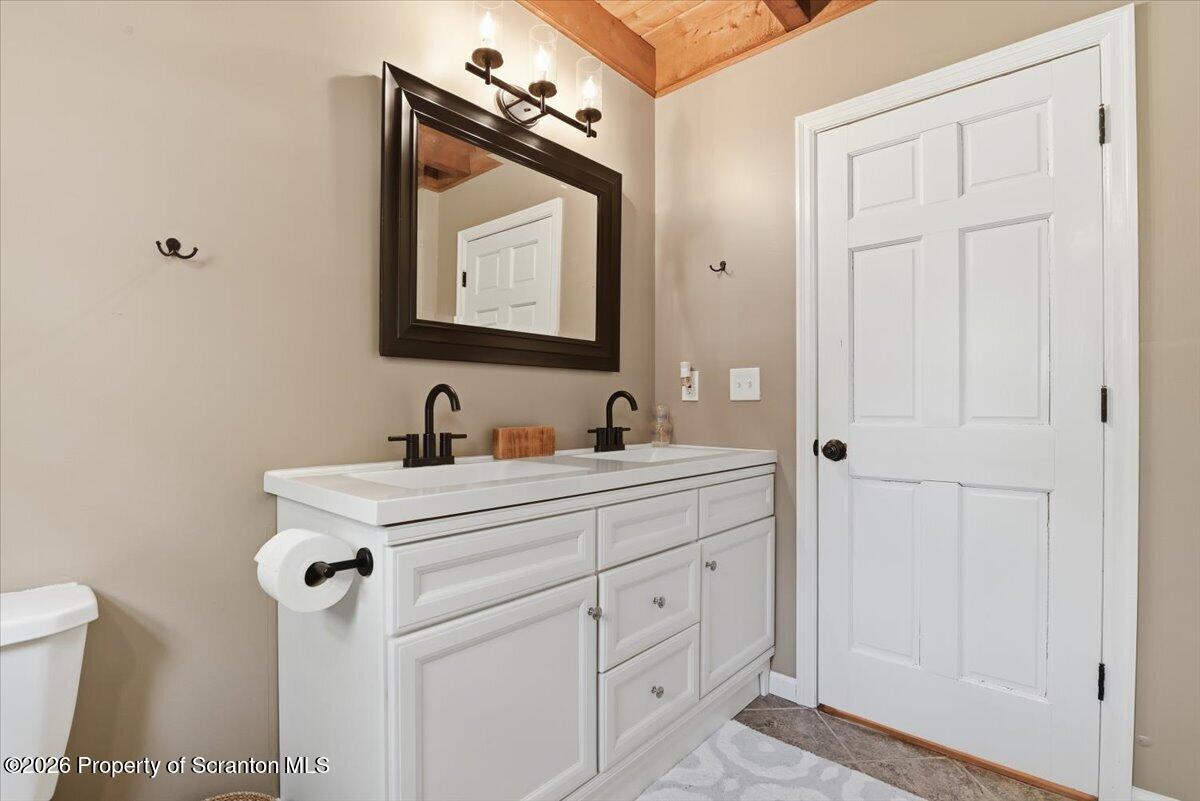 10 Knollwood Road Lake Ariel, PA 18436 - Photo 24 of 60 a bathroom with a toilet sink and mirror