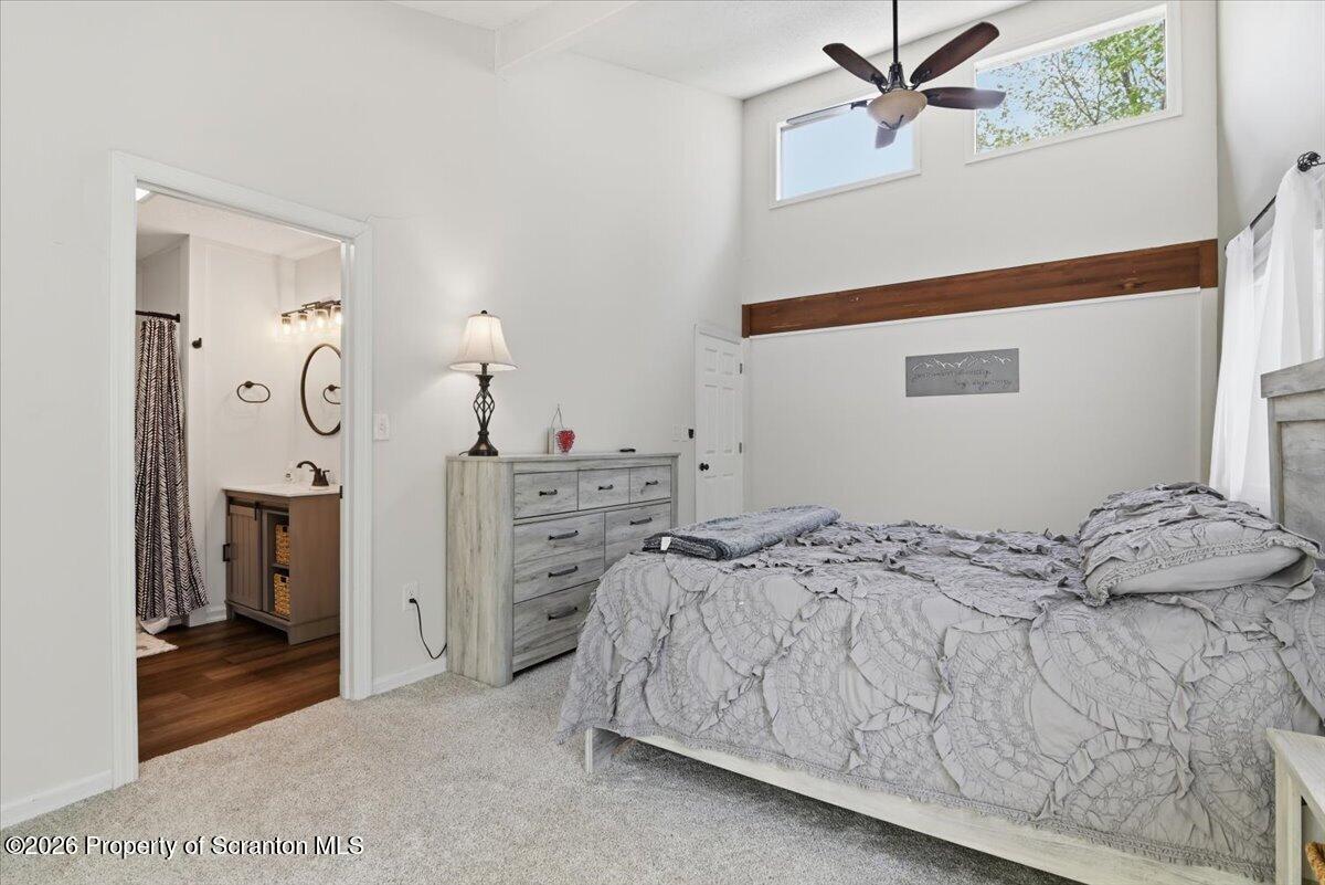 10 Knollwood Road Lake Ariel, PA 18436 - Photo 27 of 60 a bedroom with a bed and a chandelier