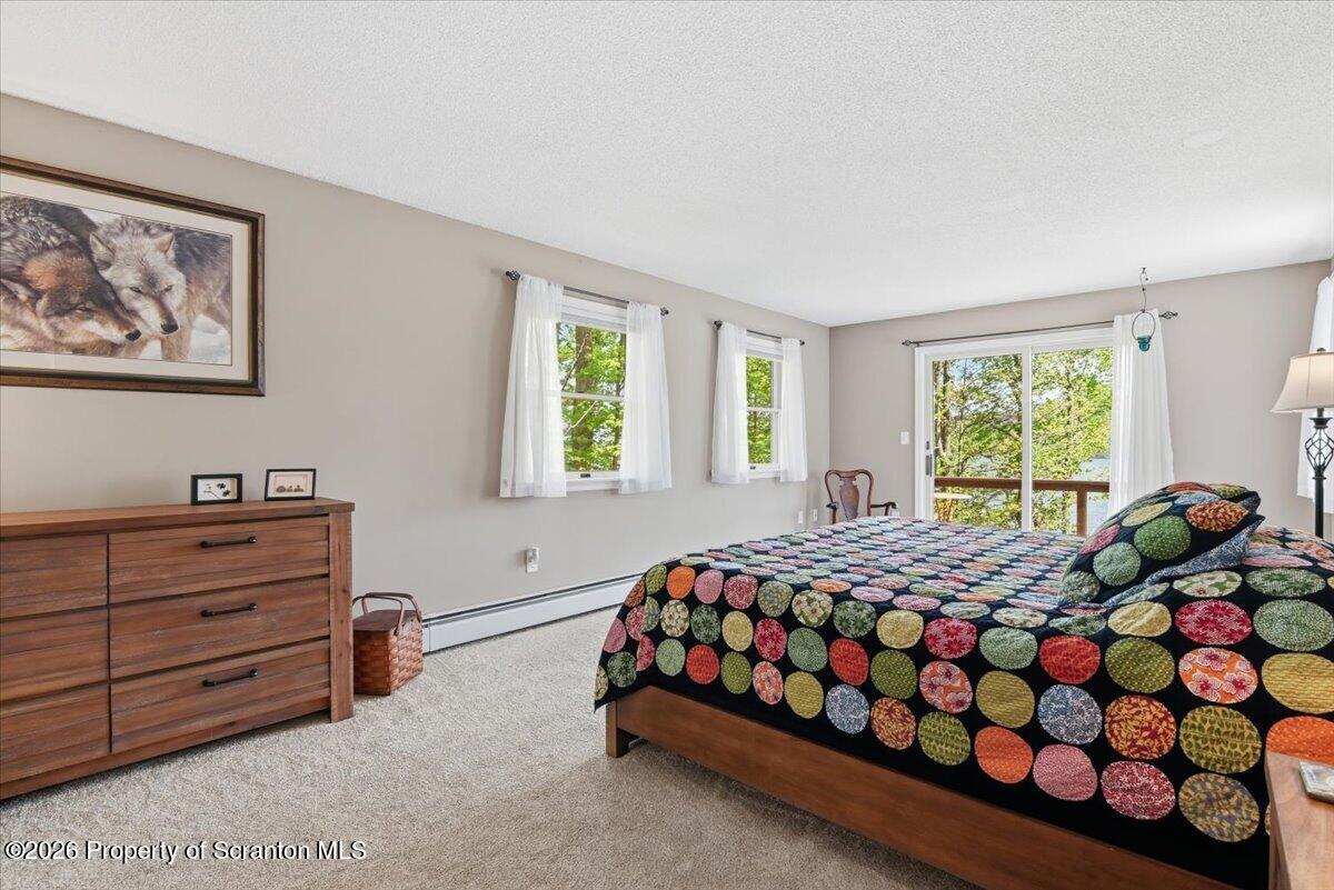 10 Knollwood Road Lake Ariel, PA 18436 - Photo 30 of 60 a bedroom with a bed window and wall painting
