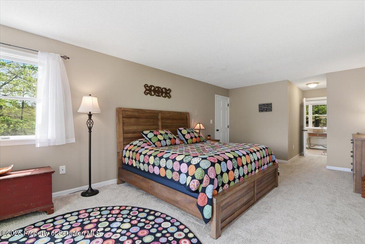 10 Knollwood Road Lake Ariel, PA 18436 - Photo 31 of 60 a bedroom with a bed rug and window