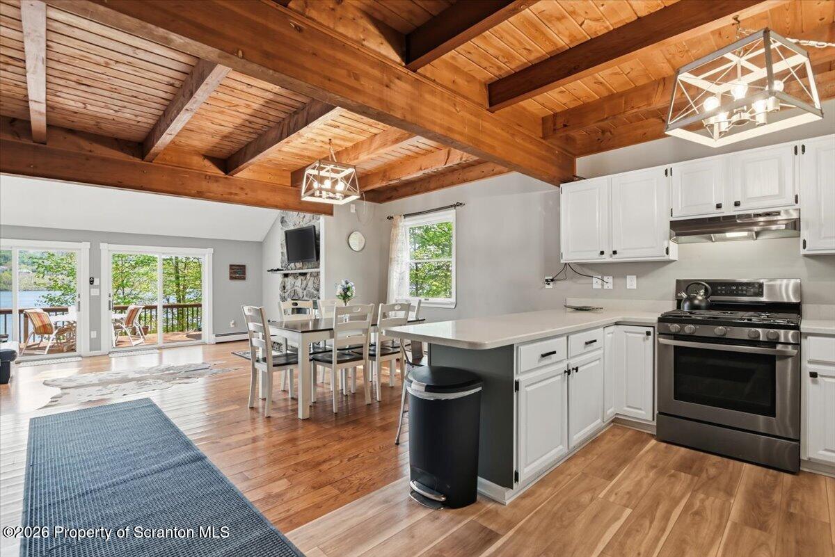 10 Knollwood Road Lake Ariel, PA 18436 - Photo 60 of 60 a kitchen with stainless steel appliances granite countertop a stove top oven a sink dishwasher and white cabinets with wooden floor