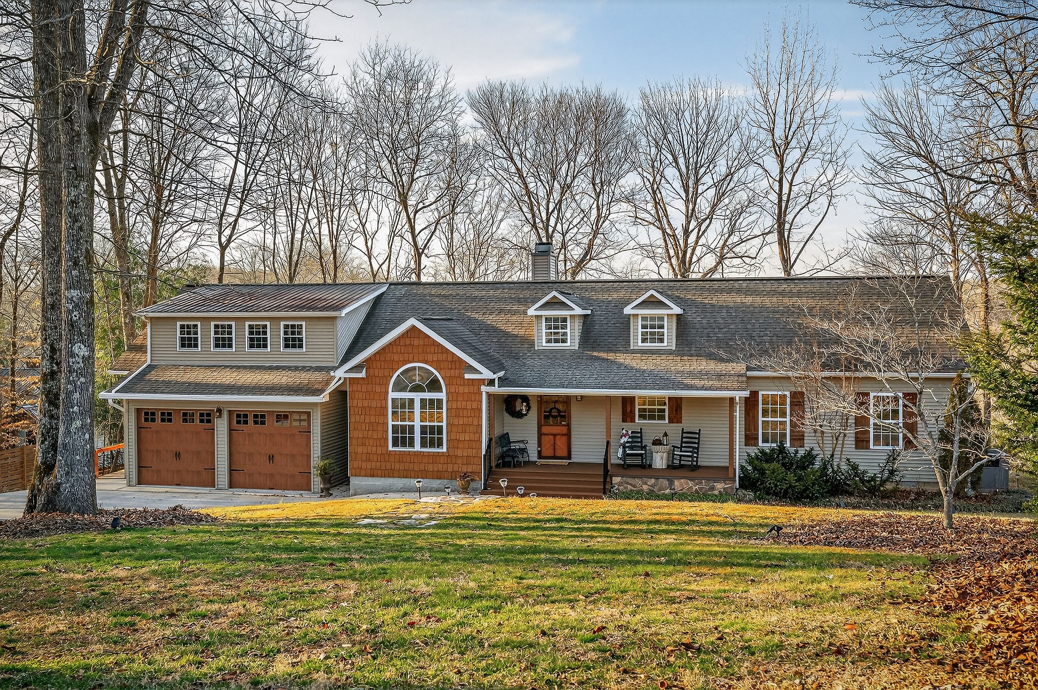 a front view of a house with a garden and plants