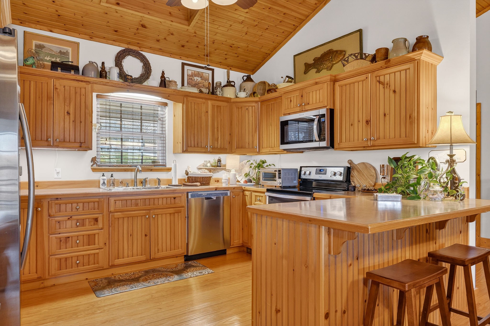 2539 Sparkman Town Road Doyle, TN 38559 - Photo 14 of 54 a kitchen with stainless steel appliances granite countertop a stove a sink dishwasher and a microwave oven with wooden cabinets
