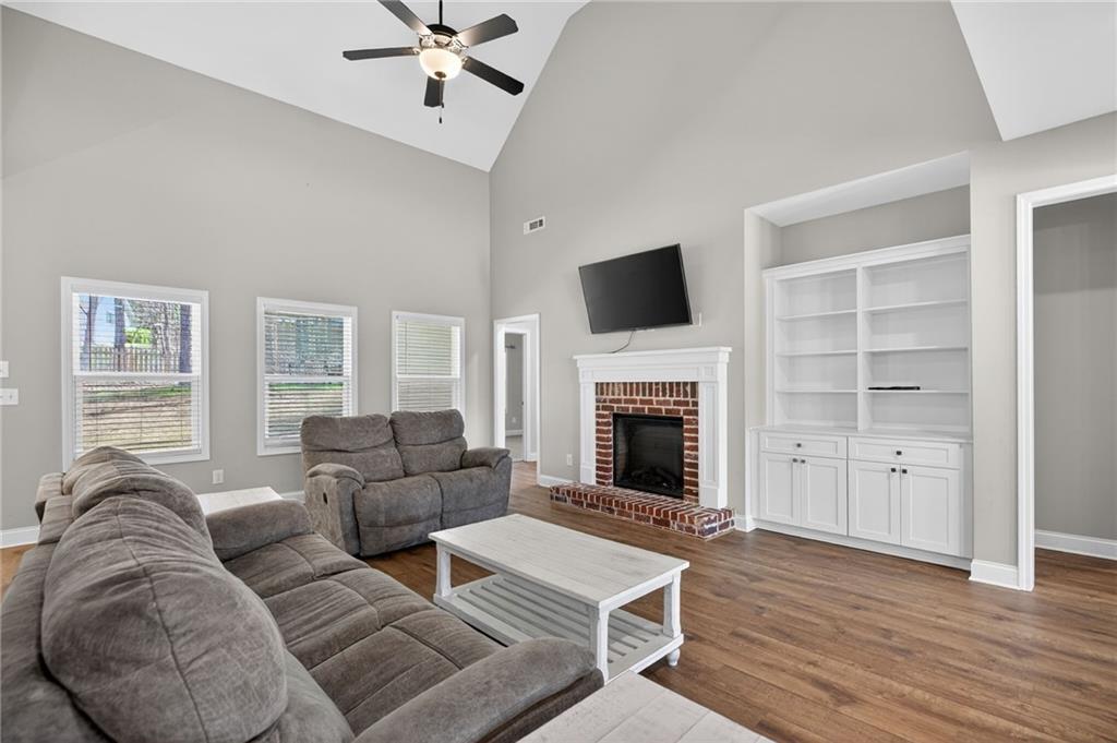 3156 Sweetbriar Drive Villa Rica, GA 30180 - Photo 11 of 45 a living room with furniture a fireplace and a flat screen tv