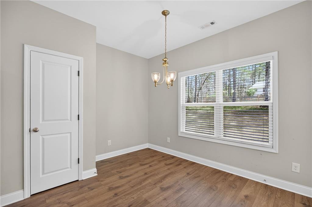 3156 Sweetbriar Drive Villa Rica, GA 30180 - Photo 15 of 45 a view of an empty room with wooden floor and a window