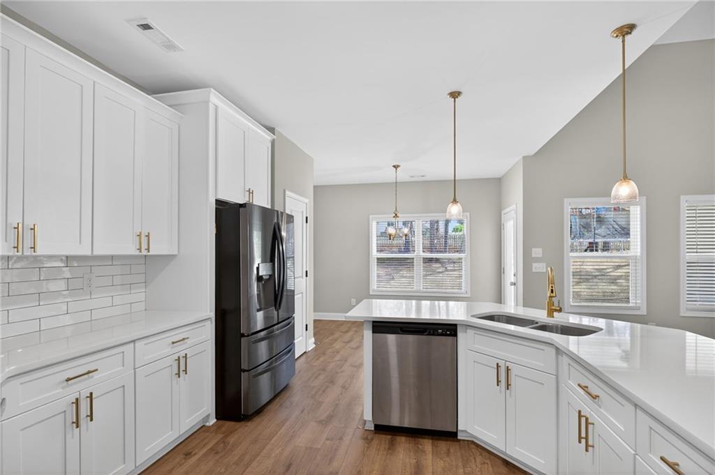3156 Sweetbriar Drive Villa Rica, GA 30180 - Photo 20 of 45 a kitchen with granite countertop a sink cabinets stainless steel appliances and a window