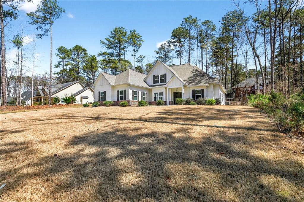 3156 Sweetbriar Drive Villa Rica, GA 30180 - Photo 2 of 45 a view of white house with a big yard and large trees