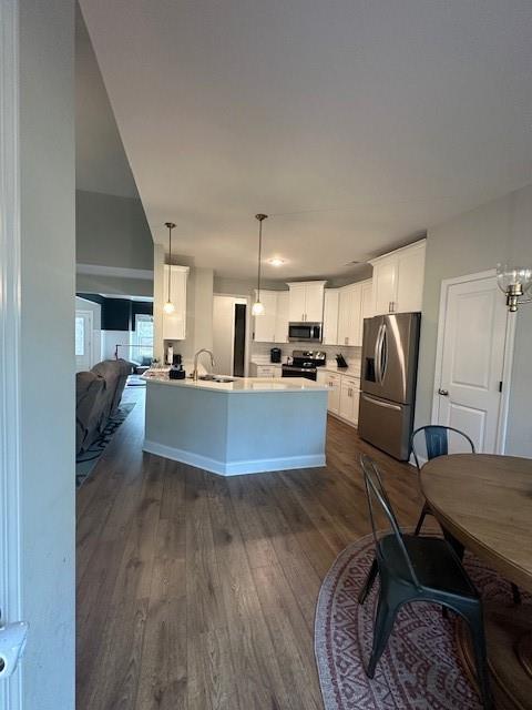 3156 Sweetbriar Drive Villa Rica, GA 30180 - Photo 21 of 39 a living room with furniture a kitchen view and a wooden floor