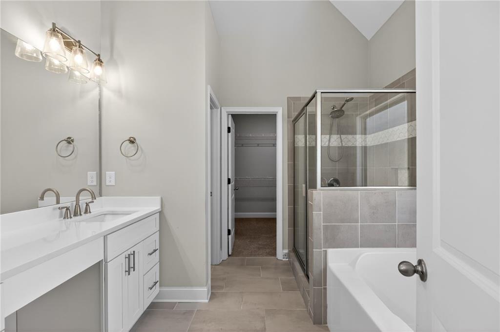 3156 Sweetbriar Drive Villa Rica, GA 30180 - Photo 25 of 45 a bathroom with a tub sink and mirror