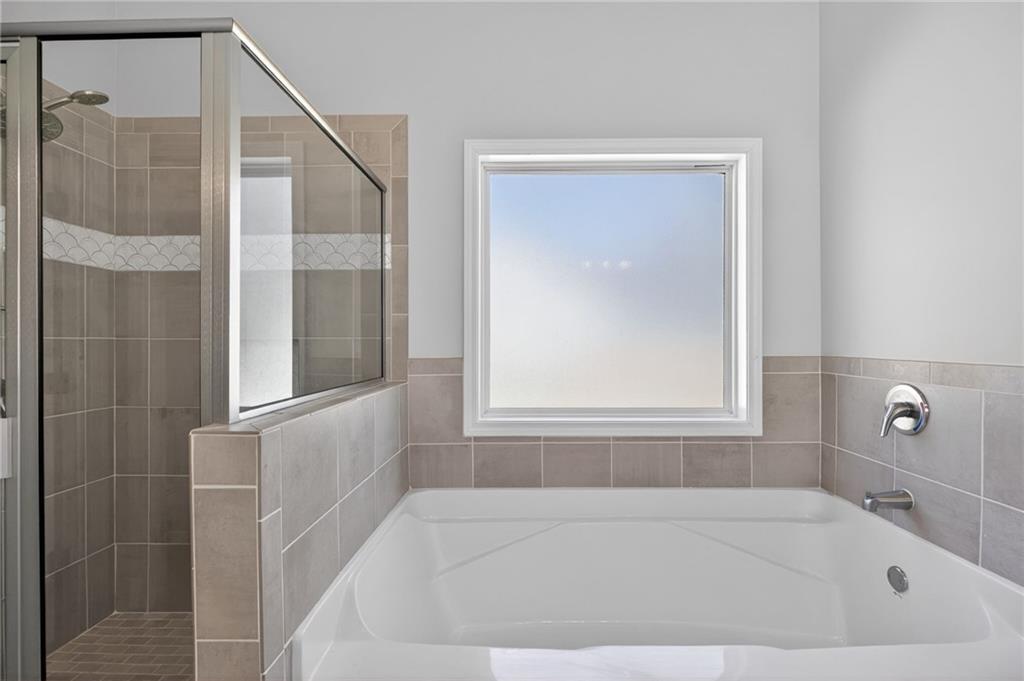 3156 Sweetbriar Drive Villa Rica, GA 30180 - Photo 27 of 45 a white bath tub sitting next to a window