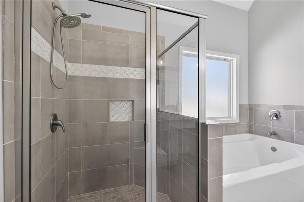 3156 Sweetbriar Drive Villa Rica, GA 30180 - Photo 28 of 45 a bathroom with a tub shower and sink