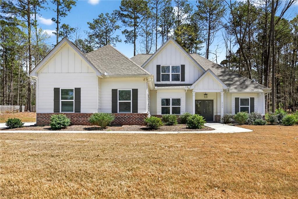 3156 Sweetbriar Drive Villa Rica, GA 30180 - Photo 3 of 45 a front view of a house with a yard