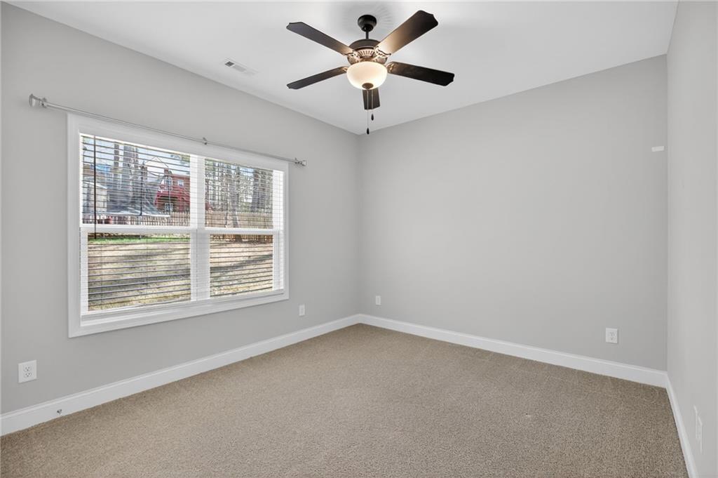 3156 Sweetbriar Drive Villa Rica, GA 30180 - Photo 32 of 45 an empty room with a window and a fan