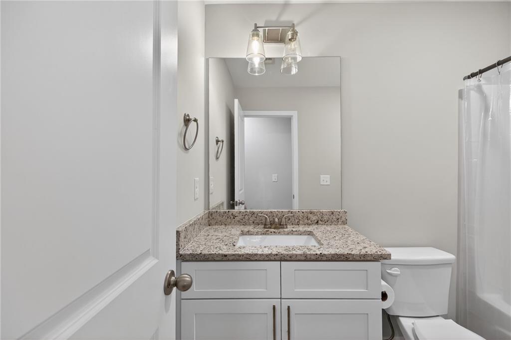 3156 Sweetbriar Drive Villa Rica, GA 30180 - Photo 36 of 45 a bathroom with a granite countertop sink and a mirror