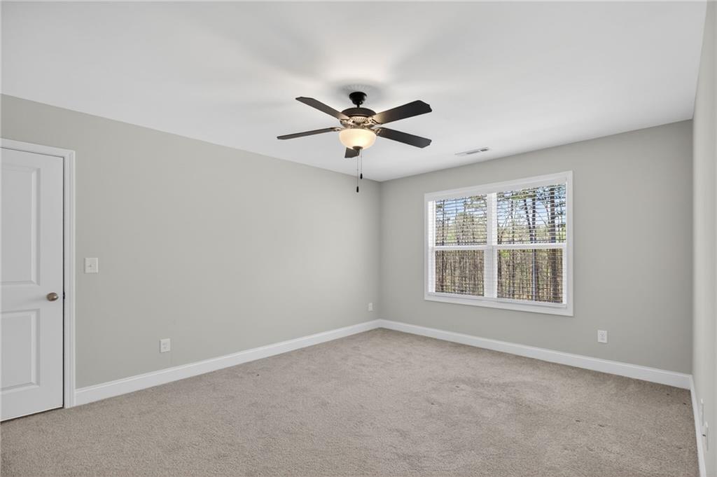 3156 Sweetbriar Drive Villa Rica, GA 30180 - Photo 37 of 45 an empty room with a window and a fan