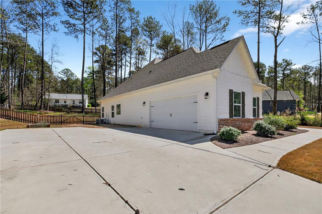 3156 Sweetbriar Drive Villa Rica, GA 30180 - Photo 39 of 45 a view of a white house with a yard and potted plants