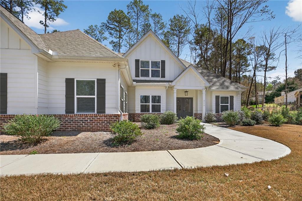 3156 Sweetbriar Drive Villa Rica, GA 30180 - Photo 4 of 45 a front view of a house with a yard and potted plants
