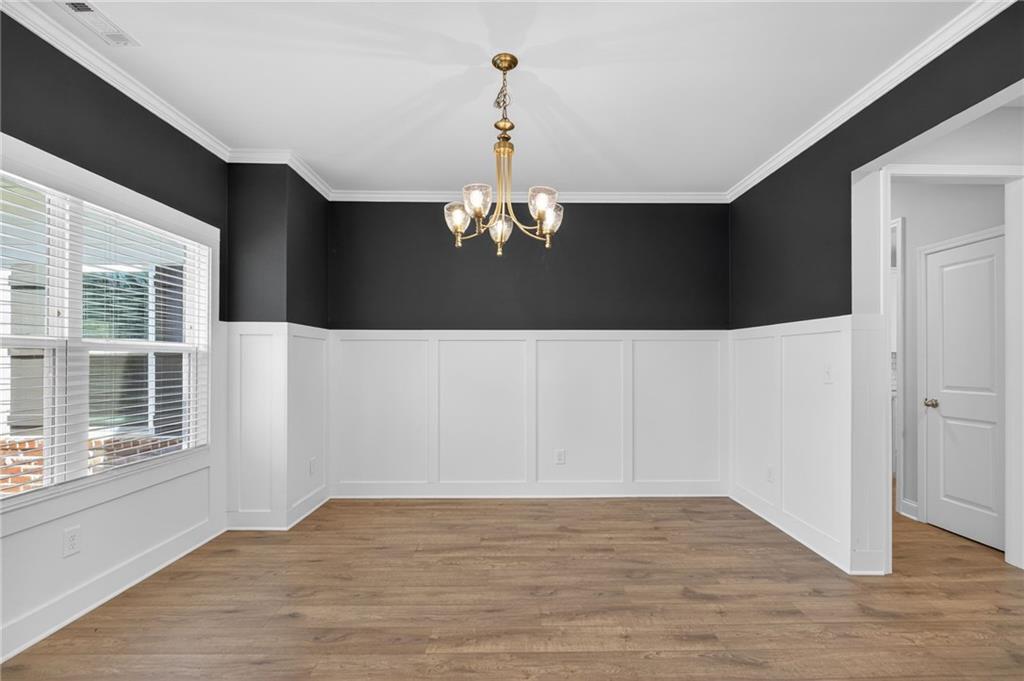 3156 Sweetbriar Drive Villa Rica, GA 30180 - Photo 7 of 45 a view of a livingroom with a chandelier fan and wooden floor