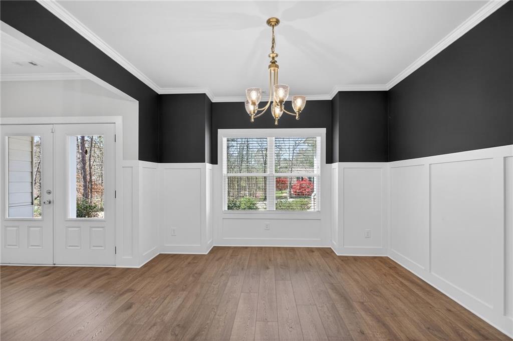3156 Sweetbriar Drive Villa Rica, GA 30180 - Photo 8 of 45 an empty room with wooden floor cabinet and windows