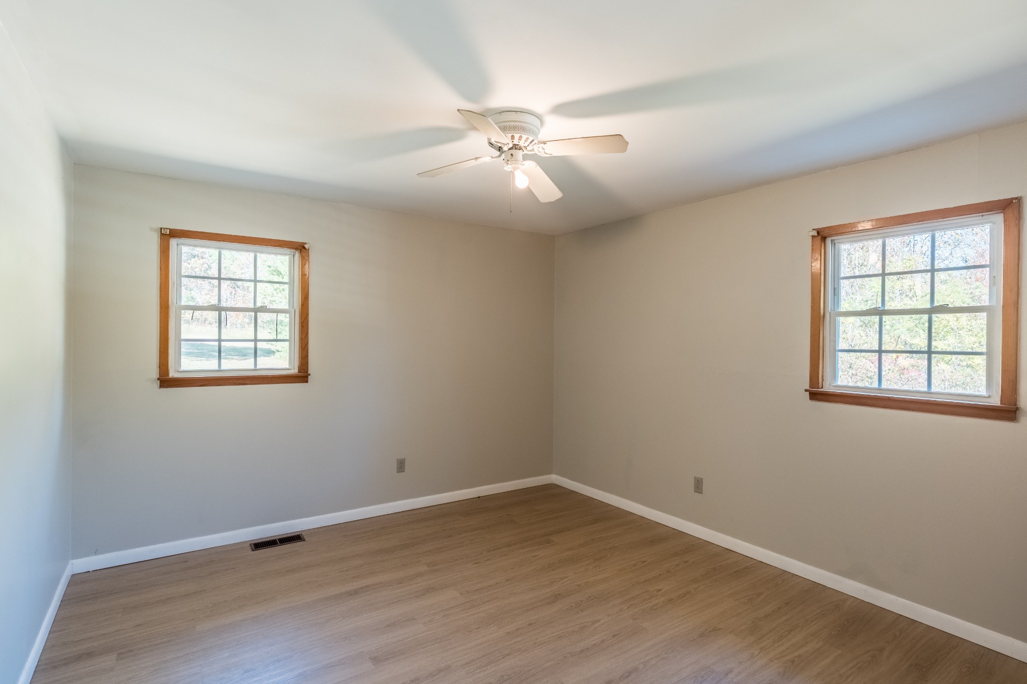 12748 Fruit Hill Red Bridge Road Crofton, KY 42217 - Photo 28 of 29 an empty room with wooden floor windows and fan
