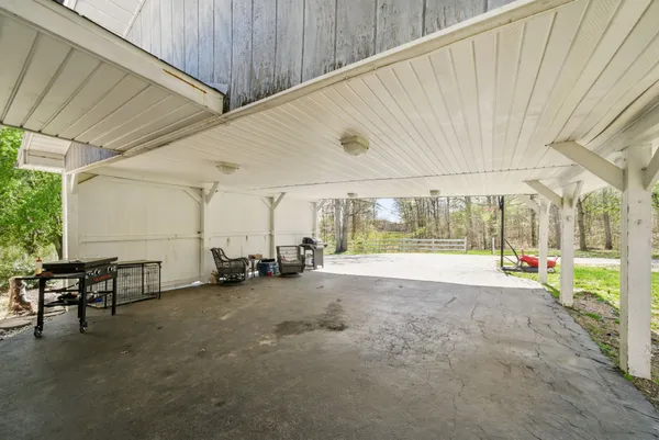 a view of a swimming pool with a patio and a yard