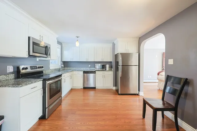 a kitchen with stainless steel appliances granite countertop a refrigerator stove microwave and sink