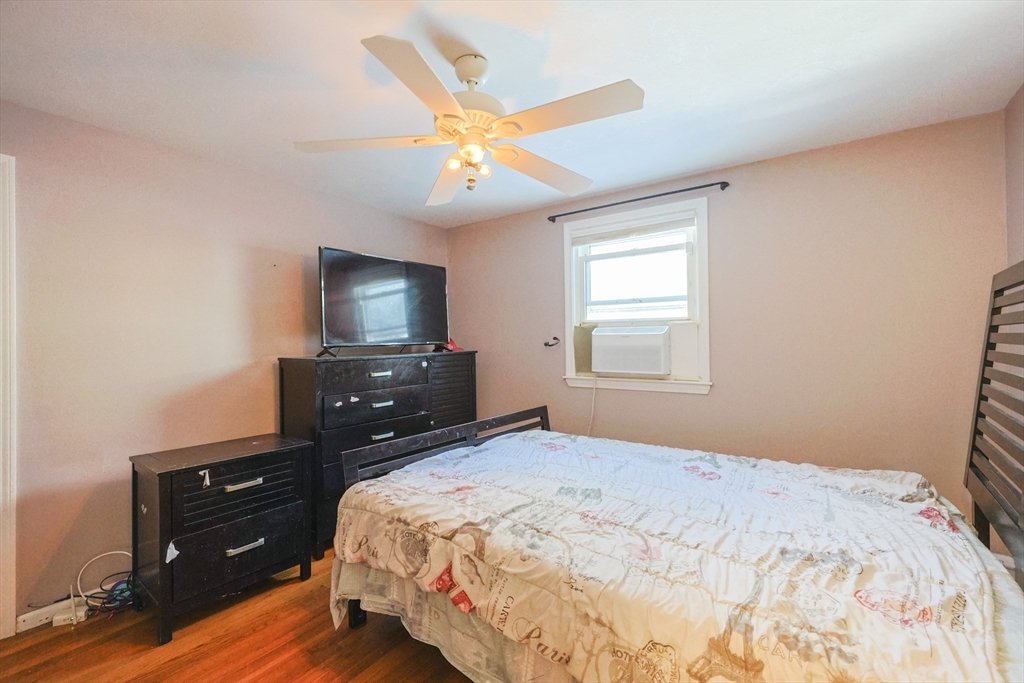 128 Salem Road Billerica, MA 01821 - Photo 16 of 42 a bedroom with a bed and a flat screen tv