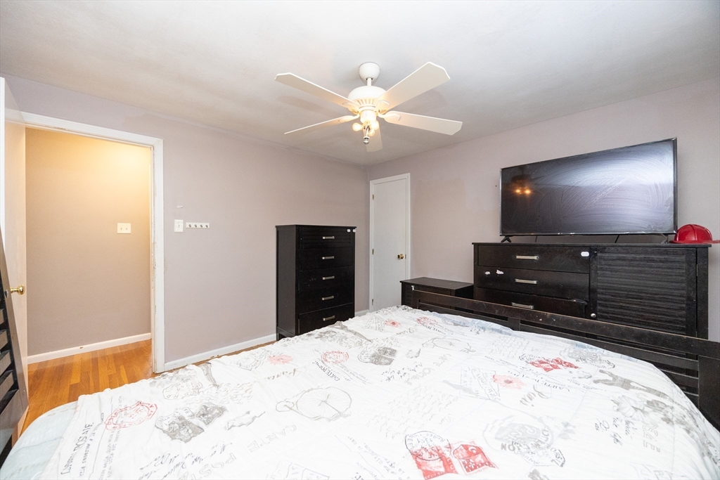 128 Salem Road Billerica, MA 01821 - Photo 17 of 42 a bedroom with a bed and a flat screen tv