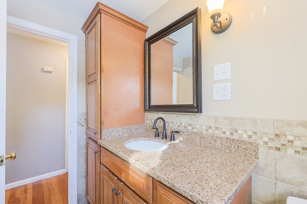 128 Salem Road Billerica, MA 01821 - Photo 21 of 42 a bathroom with a granite countertop sink and a mirror