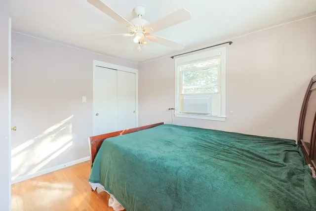 a bedroom with a bed and a window