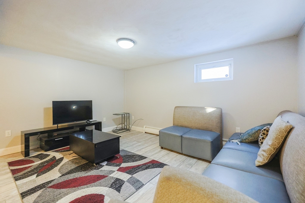 128 Salem Road Billerica, MA 01821 - Photo 34 of 42 a living room with furniture and a flat screen tv